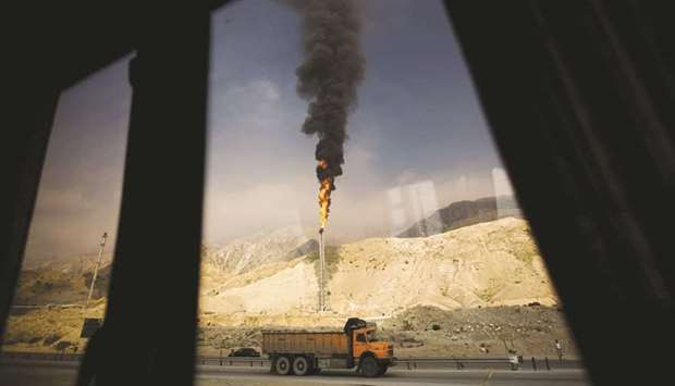 A gas flame is seen through a bus window in the South Pars gas field facilities in the southern Iranian port of Assaluyeh (file). The US has allowed Iraq to import Iranian gas for its power grid for another three months by extending a waiver to sanctions, but insists that Baghdad seek alternative sources.