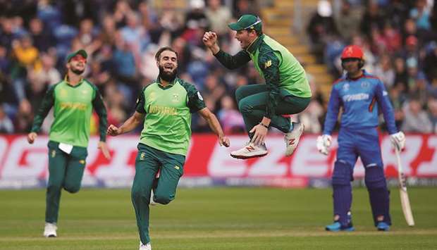 South Africau2019s Imran Tahir (second from left) celebrates with teammates after taking the wicket of Afghanistanu2019s Asghar Afghan during the 2019 ICC Cricket World Cup match in Cardiff, United Kingdom, yesterday. (Reuters)
