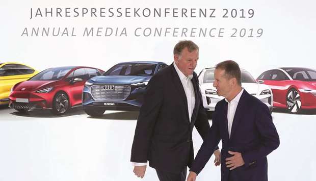 Andreas Renschler, CEO of trucks at Volkswagen (left), and Herbert Diess, CEO of VW, arrive at the automakeru2019s annual news conference in Wolfsburg, Germany, on March 12. VW intends to offer stock in Traton SE, which sells MAN and Scania AB vehicles, for between u20ac27 to u20ac33 per share, it said in a statement, valuing the division at u20ac13.5bn to u20ac16.5bn ($18.6bn).