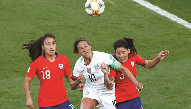 Carli Lloyd (centre) of the US battles for the ball with Chileu2019s Yessenia Huenteo and Carla Guerrero during the Womenu2019s World Cup Group F match in Paris. (AFP)