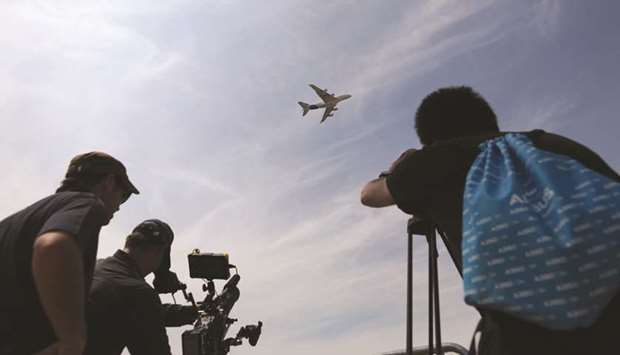 Attendees take photos and videos as an Airbus SE A380 performs during a flying display at the 53rd International Paris Air Show at Le Bourget, in Paris in June 2017. Humbled by the grounding of its 737 MAX in the wake of two fatal crashes, US plane maker Boeing will be looking to reassure customers and suppliers at this weeku2019s Paris airshow about the planeu2019s future and allay criticism of its handling of the months-long crisis.