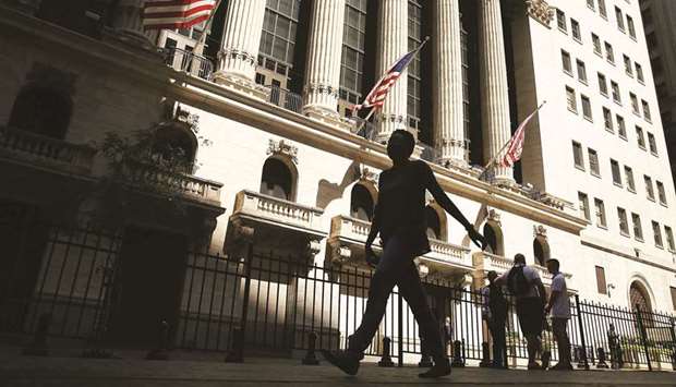 People walk by the New York Stock Exchange (file). Global markets may be too complacent in the face of major upcoming events, with mispricing evident in the options market and a risk that stocks could tumble if investors donu2019t like what they hear from the Federal Reserve, according to JPMorgan Chase & Co.