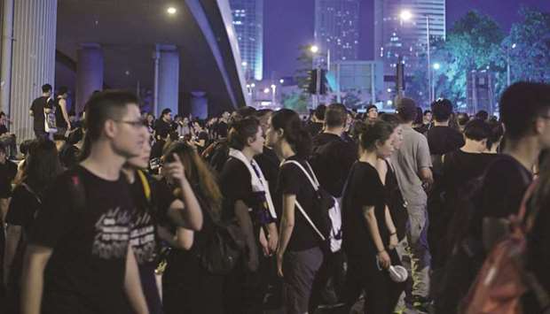 Protesters gather along a road after taking part in a march and rally against a controversial extradition law proposal in Hong Kong yesterday.