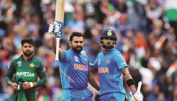Indiau2019s Rohit Sharma celebrates his century with Virat Kohli (right) during the 2019 ICC Cricket World Cup match against Pakistan at Old Trafford in Manchester, United Kingdom, yesterday. (Reuters)