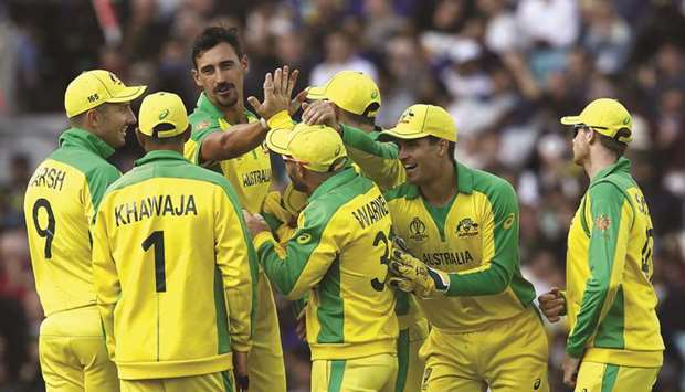 Australiau2019s Mitchell Starc (third from left) celebrates with teammates after taking the wicket of Sri Lankau2019s Thisara Perera (not pictured) during the 2019 ICC Cricket World Cup match at The Oval in London on Saturday. (AFP)