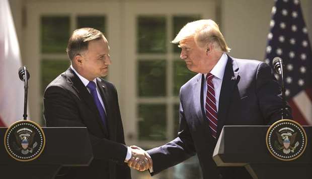 US President Donald Trump (right) shakes hands with Andrzej Duda, Polandu2019s president, during a news conference in the Rose Garden of the White House in Washington, DC. on June 12. Trump announced that 1,000 additional US soldiers would rotate through Poland, though at a base built at that governmentu2019s expense.