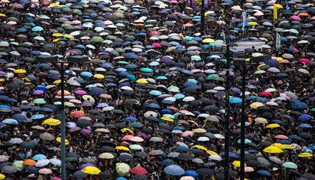 Protesters wearing black and holding umbrellas attend a new rally against a controversial extradition law proposal in Hong Kong
