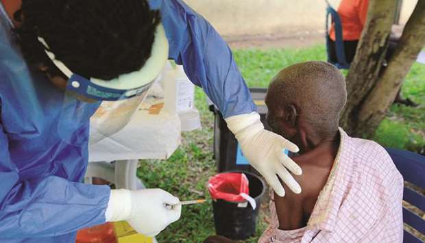 A Ugandan health worker administers Ebola vaccine to a man in Kirembo village, near the border with the Democratic Republic of Congo in Kasese district, yesterday.