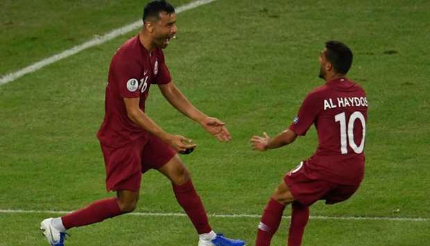 Qatar's Boualem Khoukhi (L) celebrates with teammate Hassan Al-Haydos after scoring against Paraguay during their Copa America football tournament group match at Maracana Stadium in Rio de Janeiro, Brazil. AFP