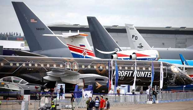 People walk past aircrafts on static display, at the eve of the opening of the 53rd International Paris Air Show at Le Bourget Airport near Paris