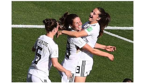 Germanyu2019s forward Melanie Leupolz (centre) celebrates with teammates after scoring against South Africa during the Womenu2019s World Cup Group B match at the Mosson Stadium in Montpellier, southern France, yesterday. (AFP)