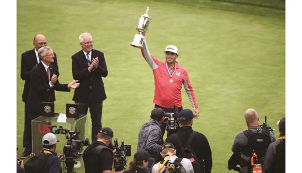 Gary Woodland of the United States celebrates with the trophy after winning the 2019 US Open at Pebble Beach Golf Links in Pebble Beach, California.