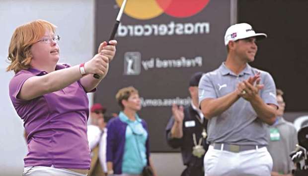 Amy Bockerstette plays a shot as Gary Woodland watches in this Golf Digest file picture.
