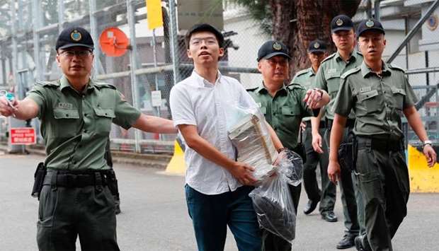 Former student leader Joshua Wong walks out from prison after being jailed for his role in Occupy Central movement, also known as ,Umbrella Movement,, in Hong Kong