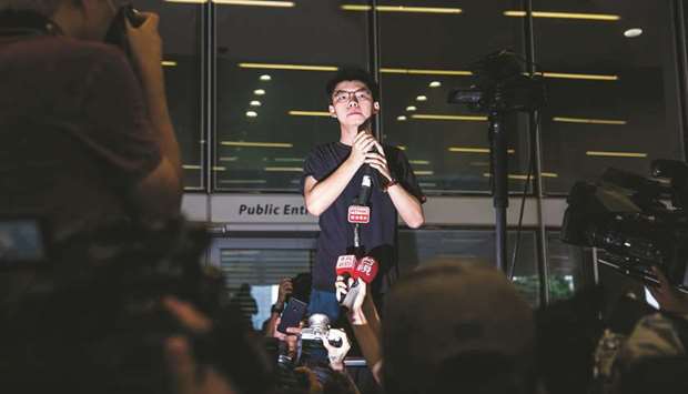 Hong Kong democracy activist Joshua Wong speaks to supporters outside the Legislative Council following his release from prison, as they rally against a controversial extradition bill in Hong Kong yesterday.