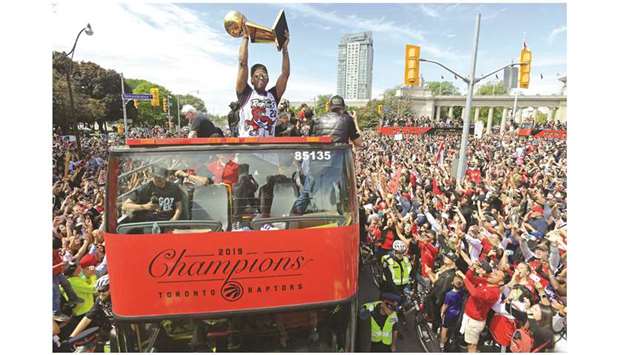 Toronto Raptorsu2019 Kyle Lowry shows the Larry Ou2019Brien trophy to fans during a parade through downtown Toronto to celebrate their NBA title triumph. (USA TODAY Sports)