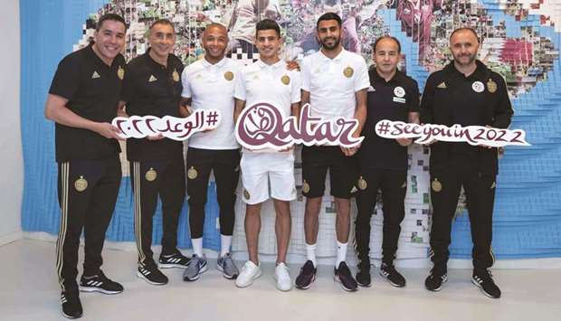 Algeria star Riyad Mahrez (third from right) and coach Djamel Belmadi (R) pose at the Supreme Committeeu2019s Legacy pavilion along with other players and officials.