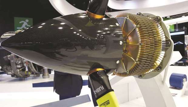 A Safranu2019s electric motor from its ENGINeUS range, designed for future hybrid and electric aircraft, on display at the international airshow at Le Bourget Airport, near Paris, yesterday. As work on fully electric aircraft continues, hybrid-electric aircraft could become a reality and take off to the skies over the coming decades, experts say.