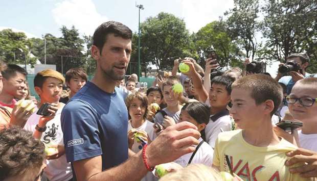 Novak Djokovic of Serbia meets with fans during a training session in Belgrade, Serbia, yesterday. (Reuters)