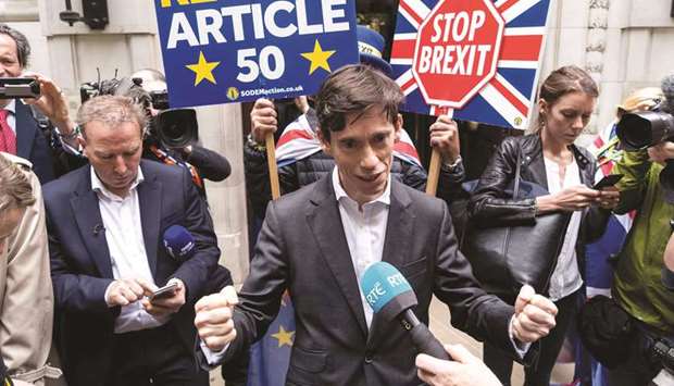 International Development Secretary Rory Stewart talks with members of the media as he leaves the Millbank televisions studios in London yesterday.