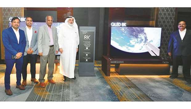 Techno Blue Qatar chairman Sheikh Nasser bin Hamad al-Thani, along with Techno Blue and Samsung officials, showcase Qataru2019s first QLED 8K TV.
