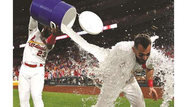 St. Louis Cardinals third baseman Matt Carpenter is doused with water by left fielder Marcell Ozuna (left) after hitting a walk off one run single during the game against Chicago Cubs at Busch Stadium. PICTURE: USA TODAY Sports