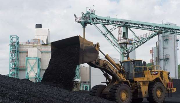 In this file photo taken on April 19, 2017 a front-end loader dumps coal at the East Kentucky Power Cooperative's John Sherman Cooper power station near Somerset, Kentucky.