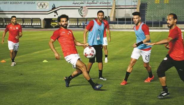 Egyptu2019s forward Mohamed Salah (second left) takes part in a training session with teammates ahead of their opening match against Zimbabwe in the Africa Cup of  Nations at the Cairo Military Academy Stadium in Cairo. (AFP)