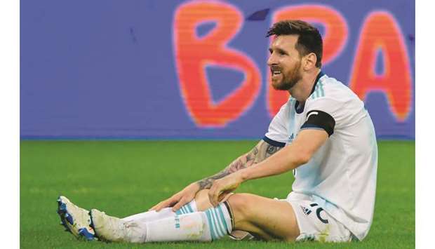 Argentinau2019s Lionel Messi sits on the ground after being fouled during the Copa America group match against Paraguay at the Mineirao Stadium in Belo Horizonte, Brazil. (AFP)
