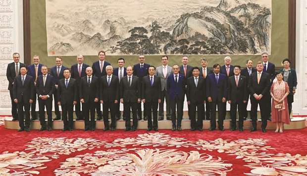 Chinese Premier Li Keqiang (centre) poses for photographs with representatives of 7th Round-Table Summit of u2018Global CEO Councilu2019 at the Great Hall of the People in Beijing yesterday.