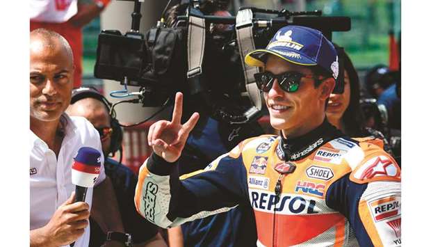 Spainu2019s Marc Marquez (R) celebrates after claiming pole position for the Italian Moto GP Grand Prix at the Mugello race track in Scarperia e San Piero yesterday.