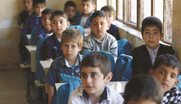 Schoolchildren attending their class at school in eastern Mosul, Iraq. Across the developing world, the average level of education is 100 years behind that of the West.