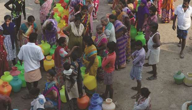 Residents queue with plastic pots to get a water from a water distribution tanker on the outskirts of Chennai. Water levels in the four main reservoirs in Chennai have fallen to one of its lowest levels in 70 years.