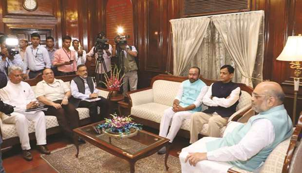 Home Minister Amit Shah meets his deputies G Kishan Reddy and Nityanand Rai and other officials after taking charge in New Delhi yesterday.