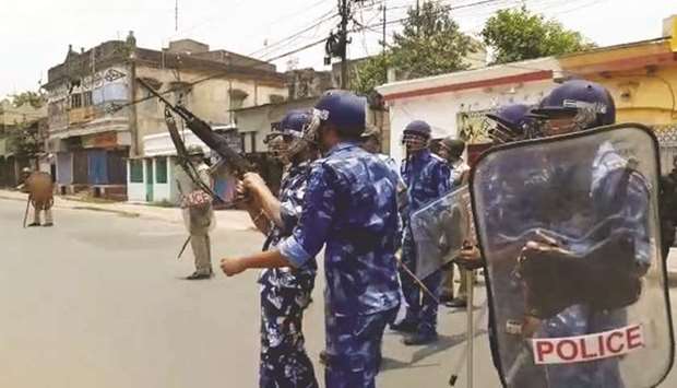 Rapid Action Force personnel patrol a street after fresh violence rocked Barrackpore in West Bengal yesterday.