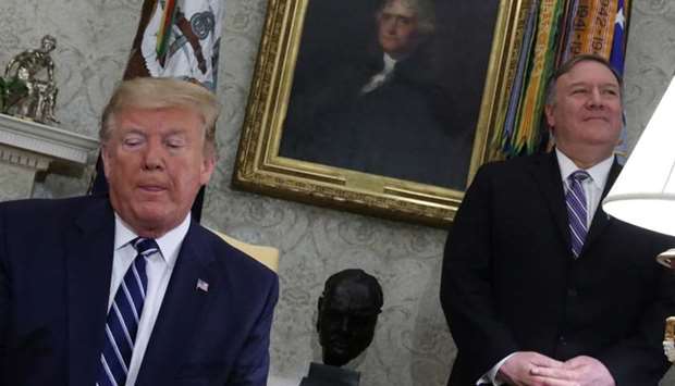 US President Donald Trump speaks during a meeting with Canada's Prime Minister Justin Trudeau as US Secretary of State Mike Pompeo stands by in the Oval Office of the White House in Washington