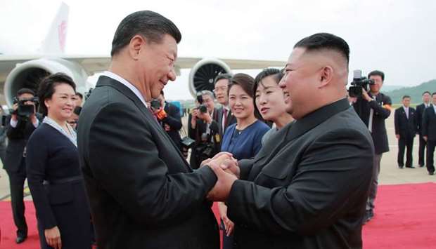 North Korean leader Kim Jong Un (R) shaking hands with Chinese President Xi Jinping upon his arrival at Pyongyang international airport in Pyongyang. June 20, 2019.