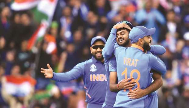 Indiau2019s Vijay Shankar (centre) celebrates with captain Virat Kohli (right) after the dismissal of Pakistanu2019s Imam-ul-Haq (not pictured) during the 2019 ICC Cricket World Cup match in Manchester on Sunday. (AFP)
