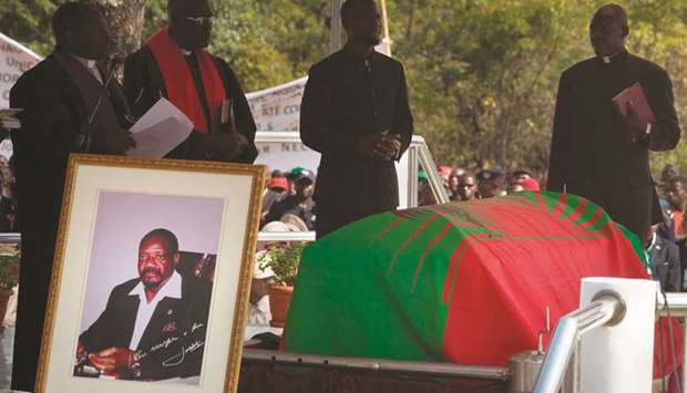 The coffin holding the remains of Jonas Savimbi, former leader of the UNITA movement is draped with a UNITA flag before the reburial yesterday, in his home village of Lopitanga, in Bie Province in Angola.