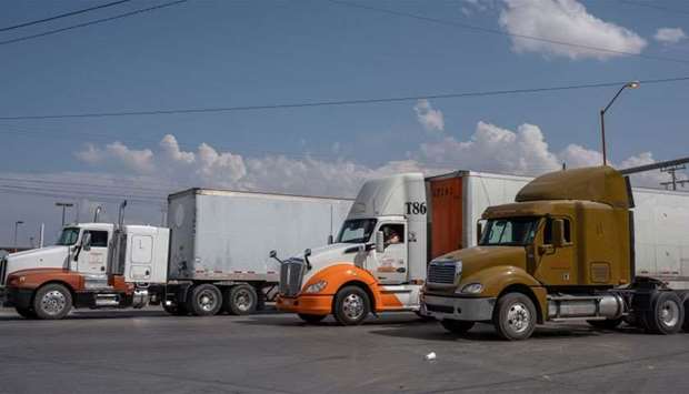 Semi-trucks wait for inspection before crossing the border at the Zaragoza International Bridge, in Juarez, Mexico, across the border from El Paso, Texas