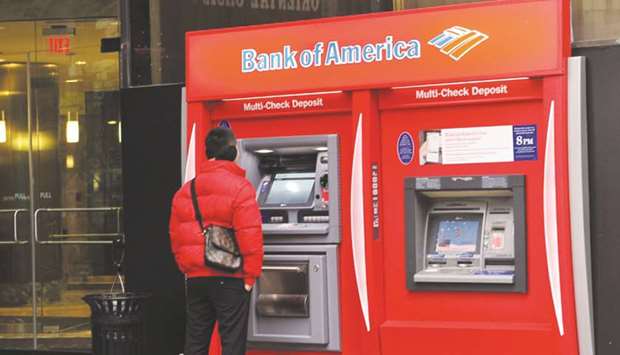 A man using a Bank of America ATM in New York. Bank of America Corp, JPMorgan Chase & Co and Citigroup have agreed to lend $450mn to TransPerfect Global to help it refinance a loan that the language- and translation-services provider got from an alternative lender last year, according to its chief executive officer Phil Shawe.