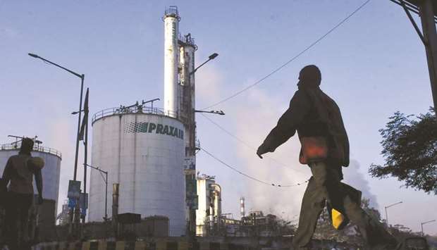 A pedestrian walks past a Tata Steel plant in Jamshedpur, Jharkhand. Indiau2019s top four steelmakers, including Tata Steel, together control over 45% of the countryu2019s total steel production.