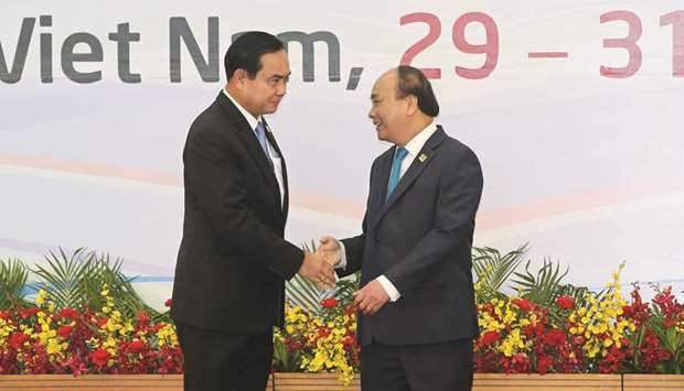 Prime Minister of Thailand Prayut Chan-o-cha shakes hands with Vietnamese Prime Minister Nguyen Xuan Phuc at the National Convention Centre in Hanoi (file). Southeast Asian leaders are eager to sign a sweeping China-led trade pact by the end of this year, Thailandu2019s prime minister said yesterday, with further talks expected at a Bangkok summit on the worldu2019s biggest commercial deal.