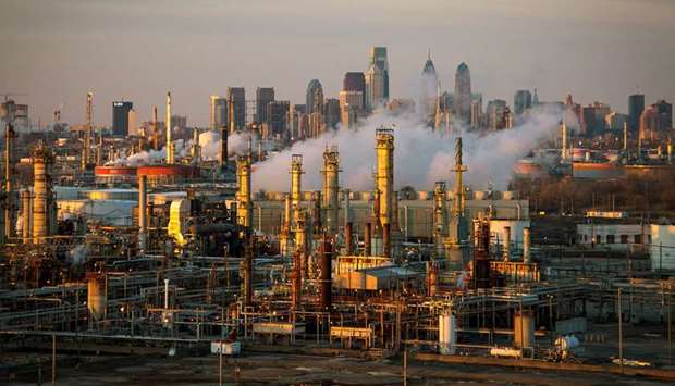 This file picture shows the Philadelphia Energy Solutions oil refinery at sunset in front of the  Philadelphia skyline.