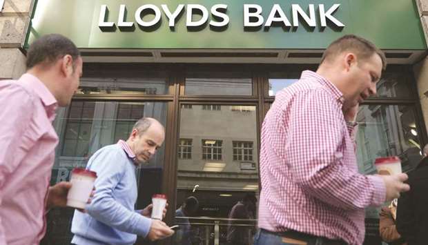 Pedestrians walk past a Lloyds bank branch in London. The u00a345.5mn fine is a further embarrassment for Lloyds as banks continue to pay for misbehaviour during the financial crisis a decade ago when Britain had to bail out several lenders.