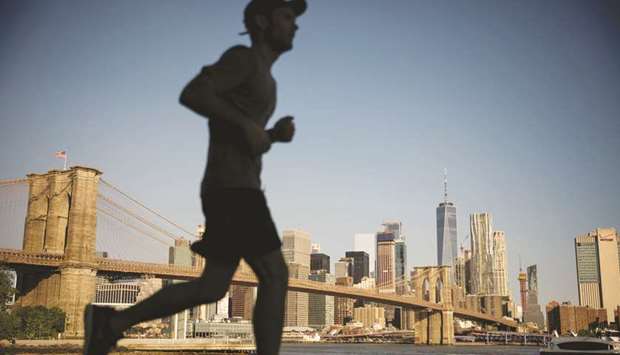 A jogger runs in Main Street Park in the Brooklyn borough of New York, US. The US economy has entered its 11th year of uninterrupted expansion, breaking the previous record for the longest period of growth in American history without a recession. PICTURE: Michael Nagle/Bloomberg