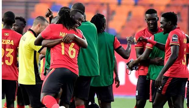 Ugandan players celebrate after winning the 2019 Africa Cup of Nations (CAN) football match between DR Congo and Uganda at Cairo International Stadium