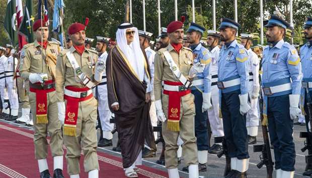 His Highness the Amir Sheikh Tamim bin Hamad Al-Thani inspects a guard of honor during the welcome ceremony.