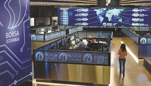 Employees work in their booths at the Borsa Istanbul stock exchange in Istanbul (file). The Istanbul exchange started publishing quotes for the Turkish lira overnight reference rate, or TLREF, on Monday.