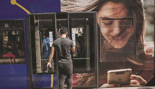 A passenger using a mobile phone prepares to board a city tram in Istanbul (file). The new measures aim to boost domestic spending, a key driver of Turkeyu2019s economy.